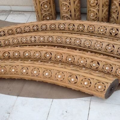 Hand-carved wooden arch segments with rosette detail
