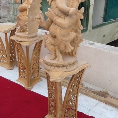 Carved wooden Ganesh figures on matching pedestals