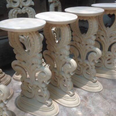 Pedestal tables with scrolled, carved bases