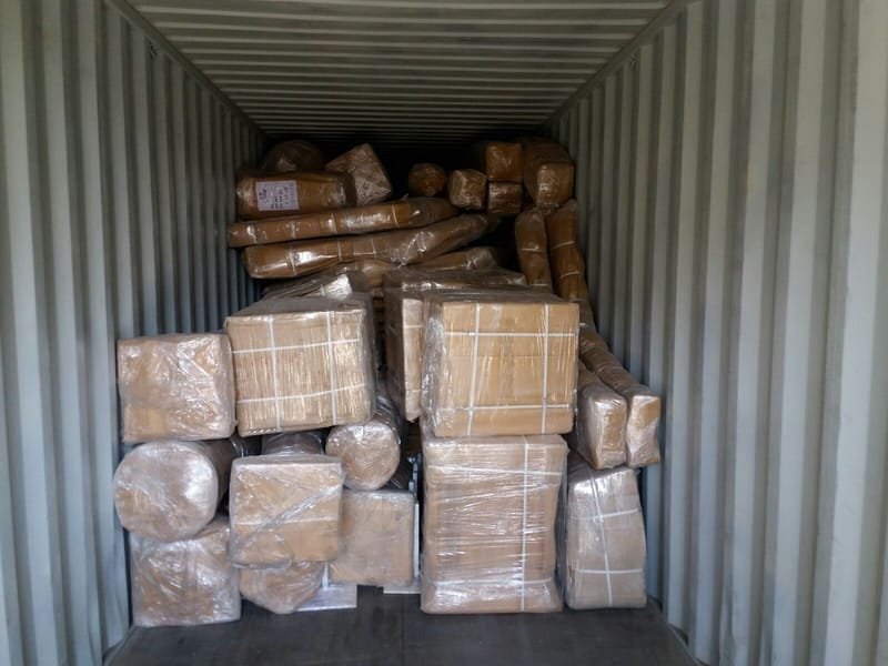 Packed boxes and parts stacked inside a container