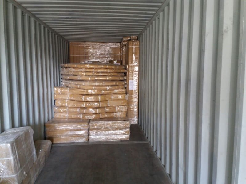Export cartons stacked floor to ceiling in a container